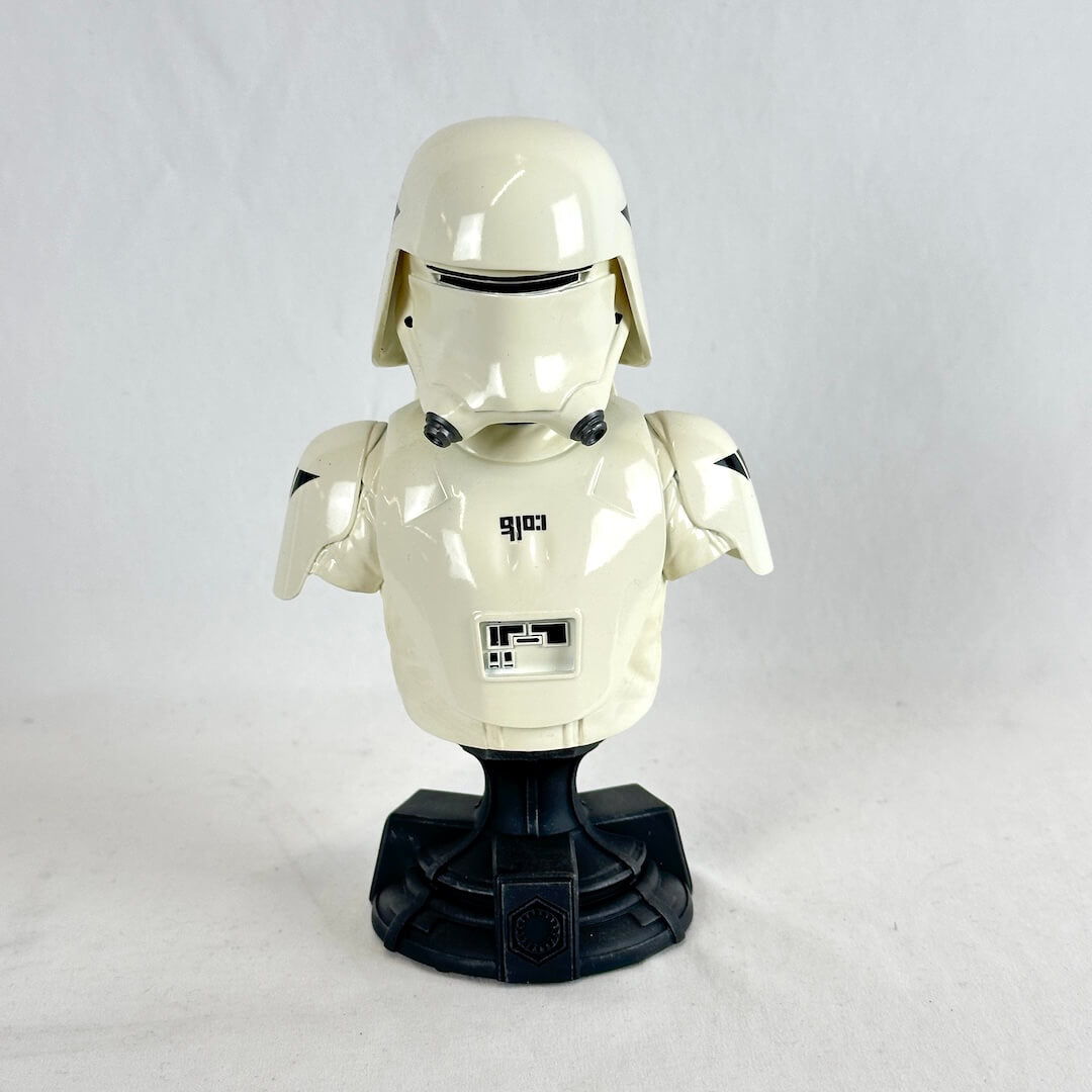 A glossy white plastic bust of a Star Wars First Order Stormtrooper helmet and upper body, mounted on a black display stand.
