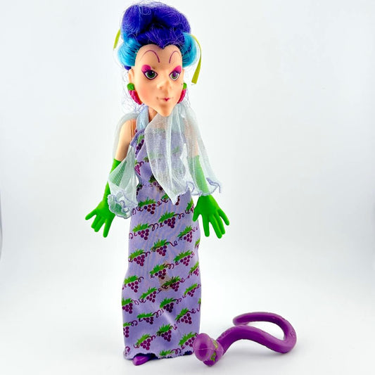 Toy figure with purple hair and dress on a white background
