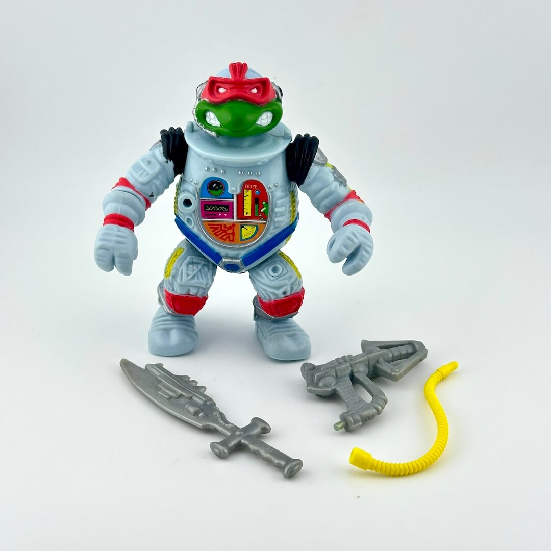 TMNT turtle action figure with accessories on white background. 