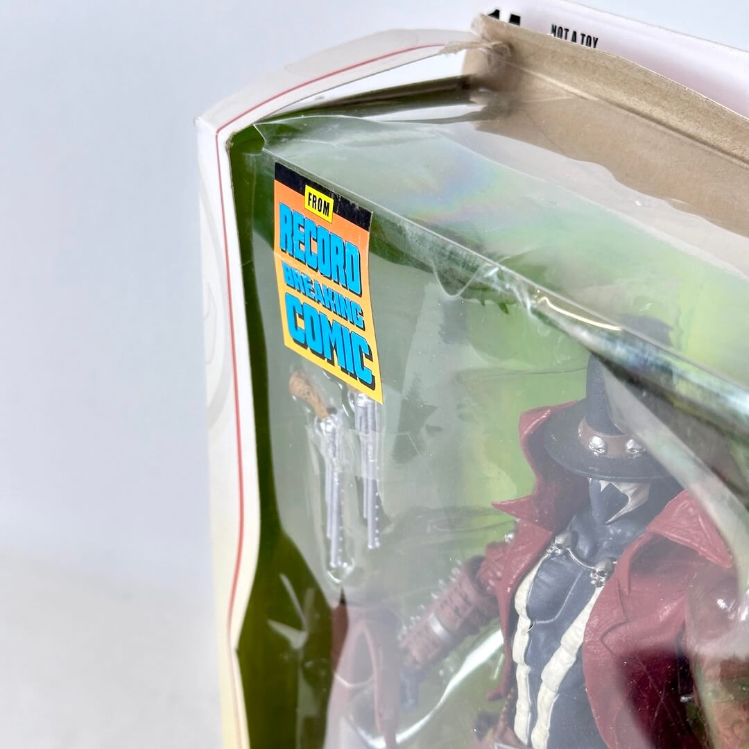 Close-up of wear to top left of packaging. 