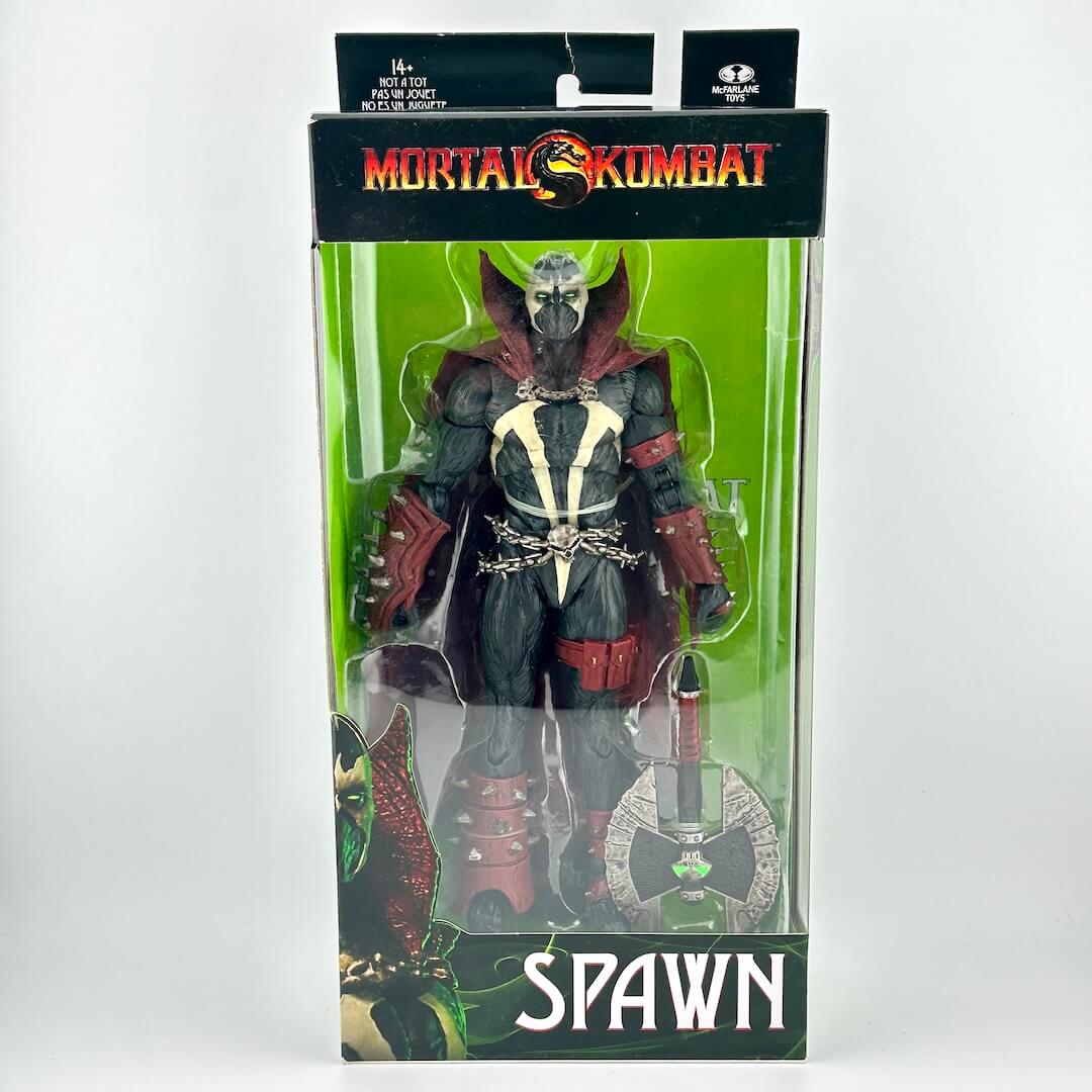 Mortal Kombat Spawn action figure in original retail packaging with accessories and green background. 