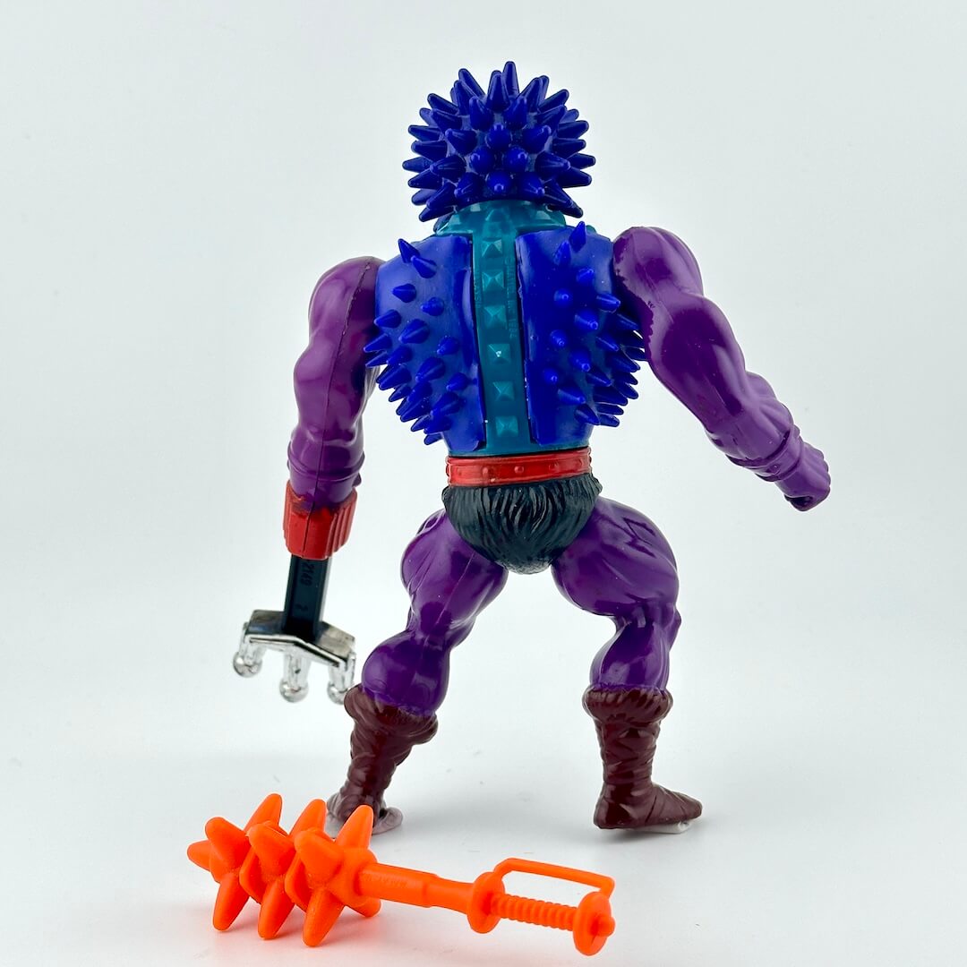 Action figure with blue spikes covering chest and head, and purple arms and legs. 
