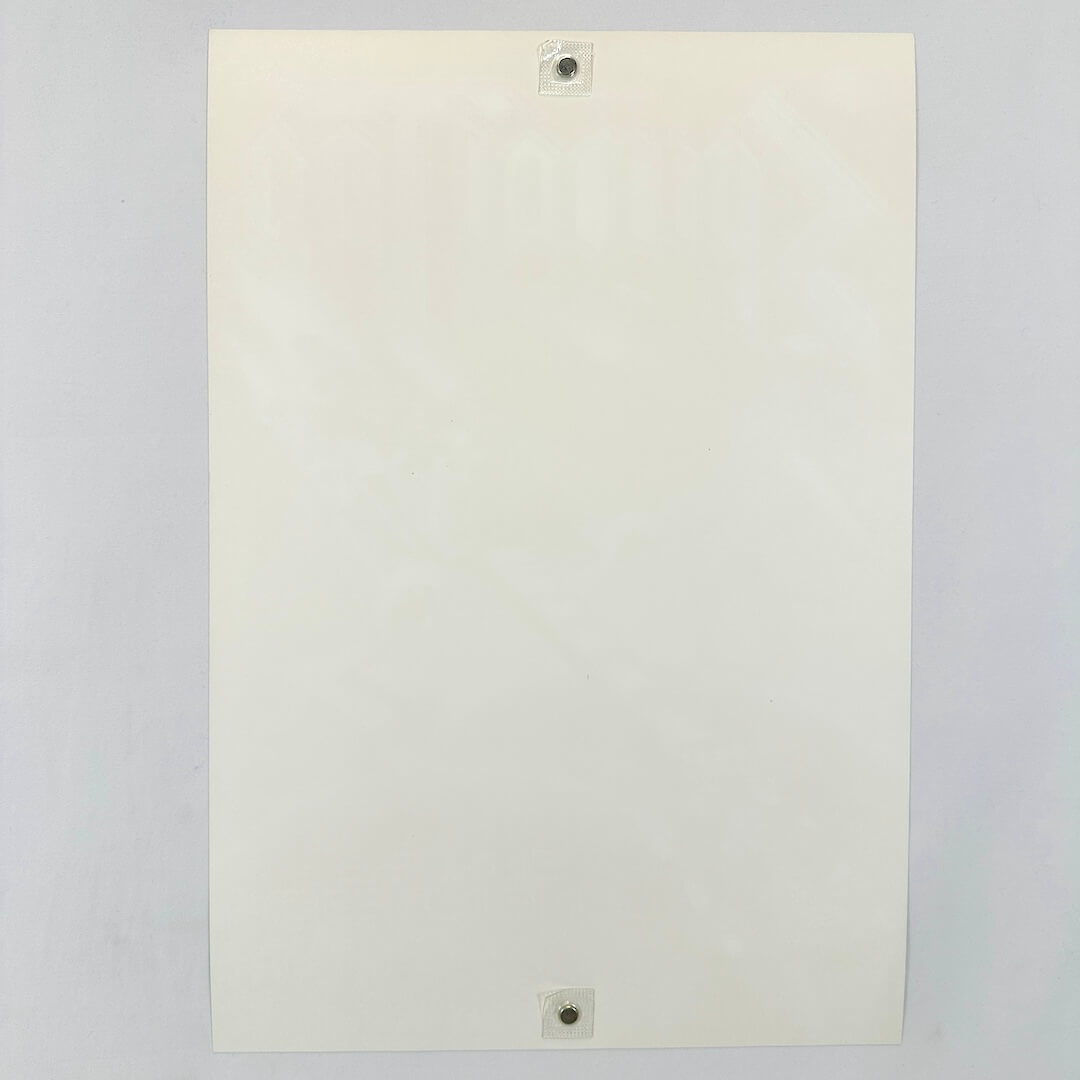 Backside of white poster to show zero damage and pristine condition against a white background. 