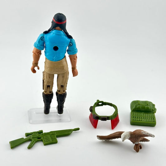 GI Joe action figure with accessories on white background. 