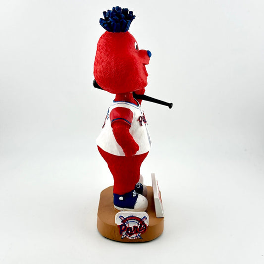 Red and white mascot figurine with blue accents on a white background