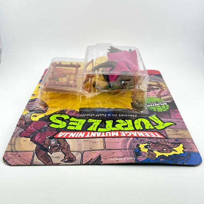 Toy figure in packaging with Teenage Mutant Ninja Turtles theme.
