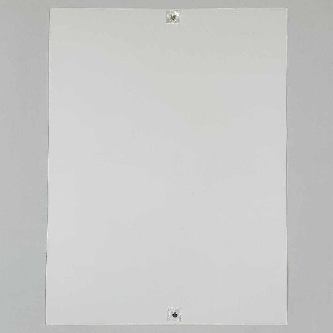 Backside of white poster against white background. 