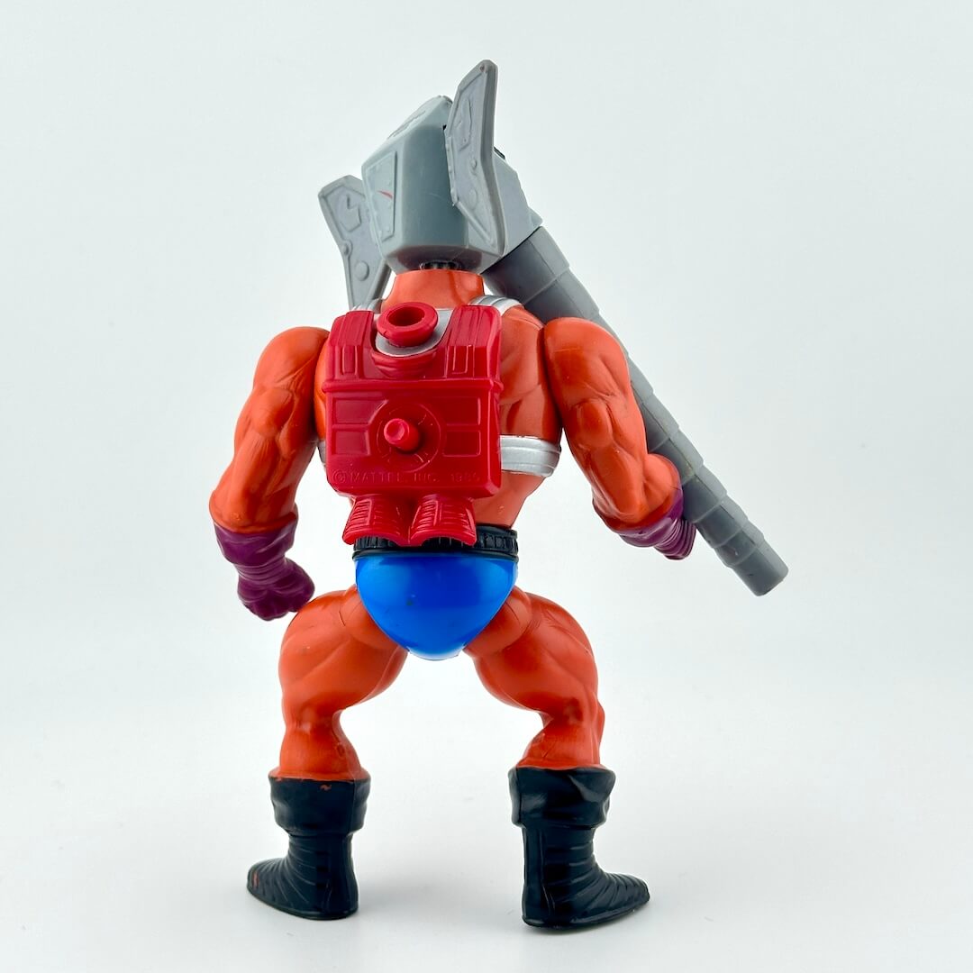 Action figure with man body and elephant head wearing orange bodysuit. 
