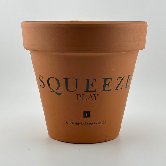 Terracotta clay flower/plant pot with Squeeze, Play, & Reprise Record copyright info printed on side. 