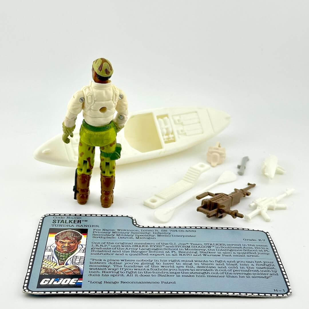 Vintage GI Joe action figure with accessories and card on a white background