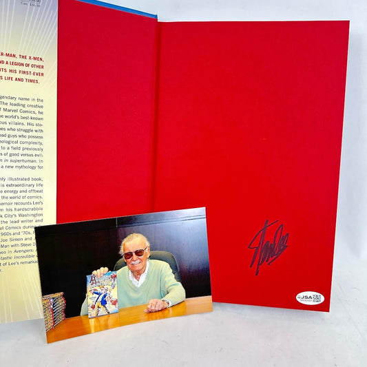 Inside cover of book with signature and photograph of Stan Lee with book. JSA sticker in corner. 