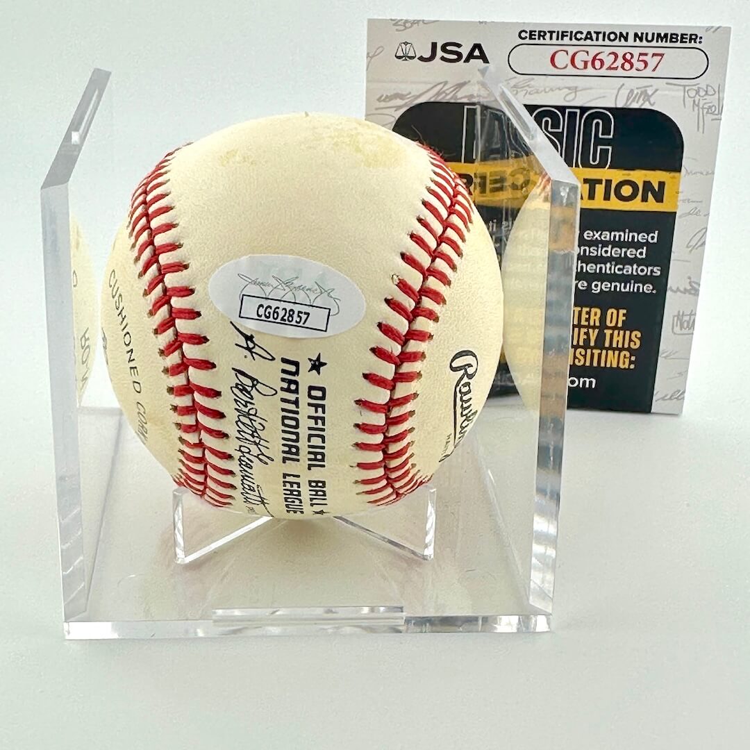 Baseball in a clear display case with JSA certification behind it