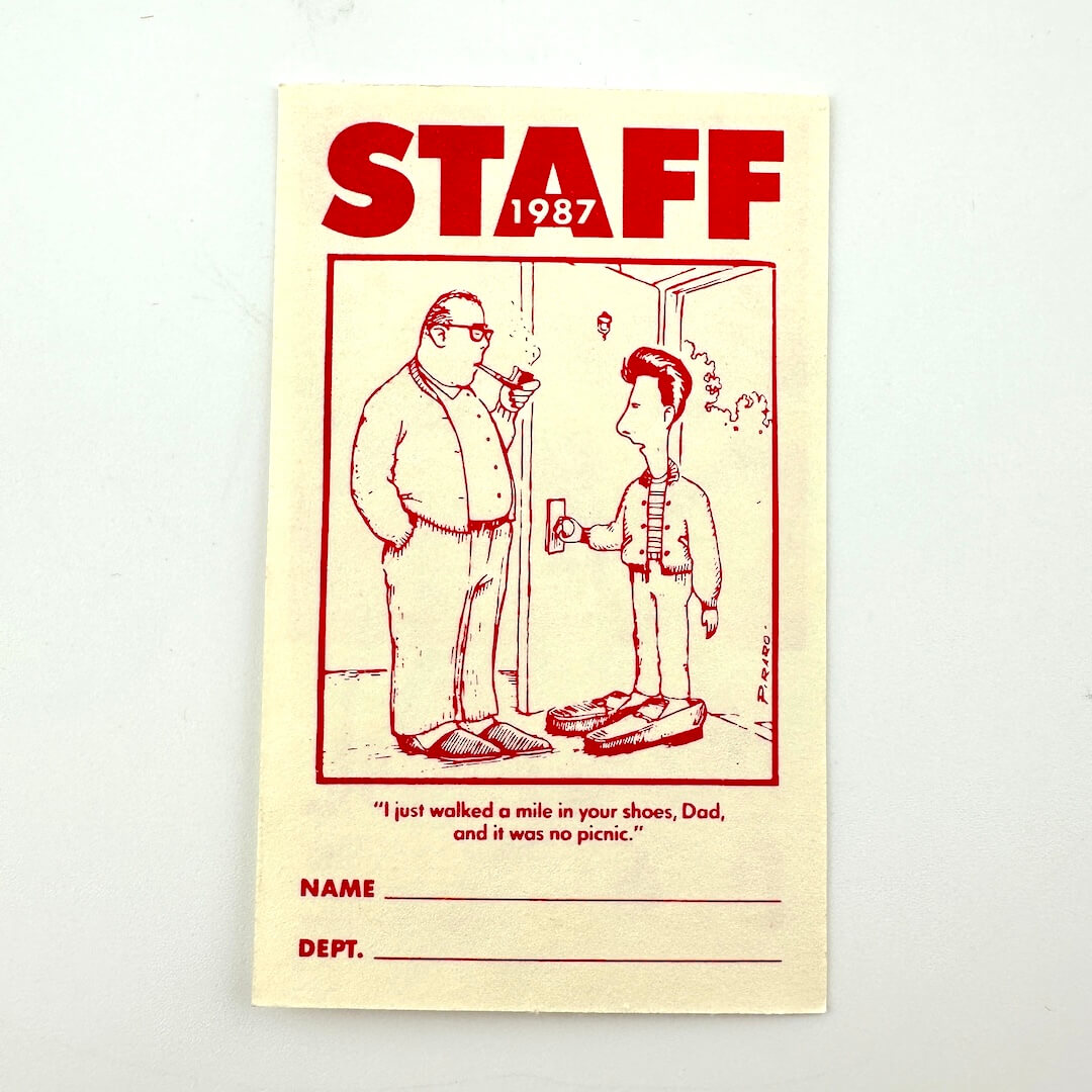Vintage-style ticket with illustration of two men and text, labeled 'Staff 1987'.