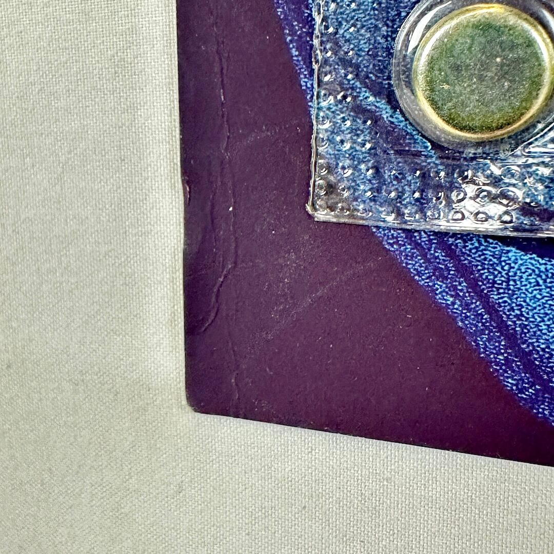 Close-up of light crease at bottom left corner.