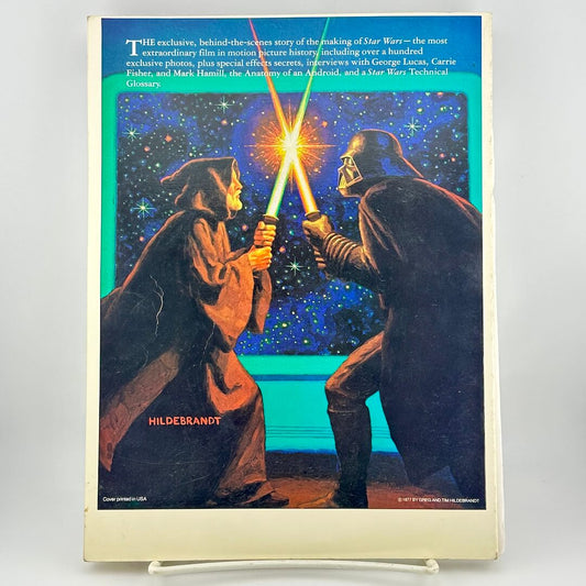 Book cover with illustration of two characters facing each other with lightsabers, against a space-themed background.