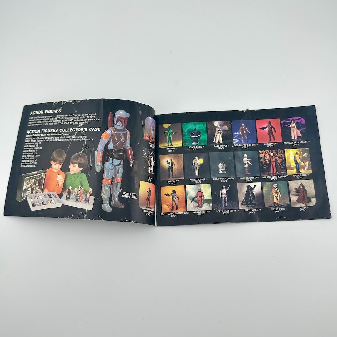 Open book showing action figures and collectible items on a white background