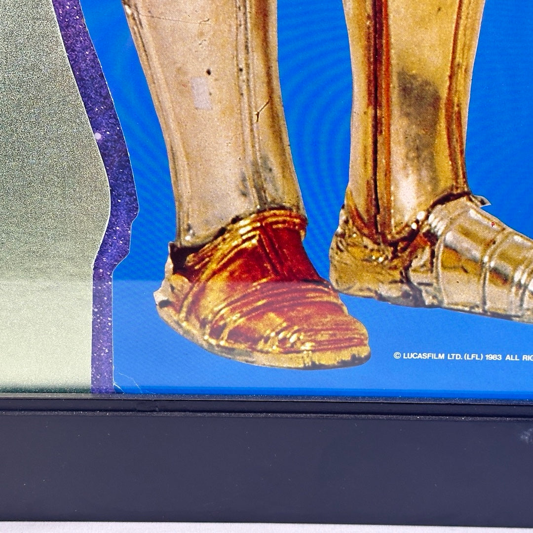 Close up of C3PO's foot with slight bend in corner by the 1983 copyright information for Lucasfilm Ltd.