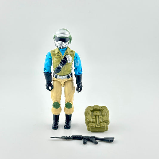 GI Joe action figure with accessories against white background. 