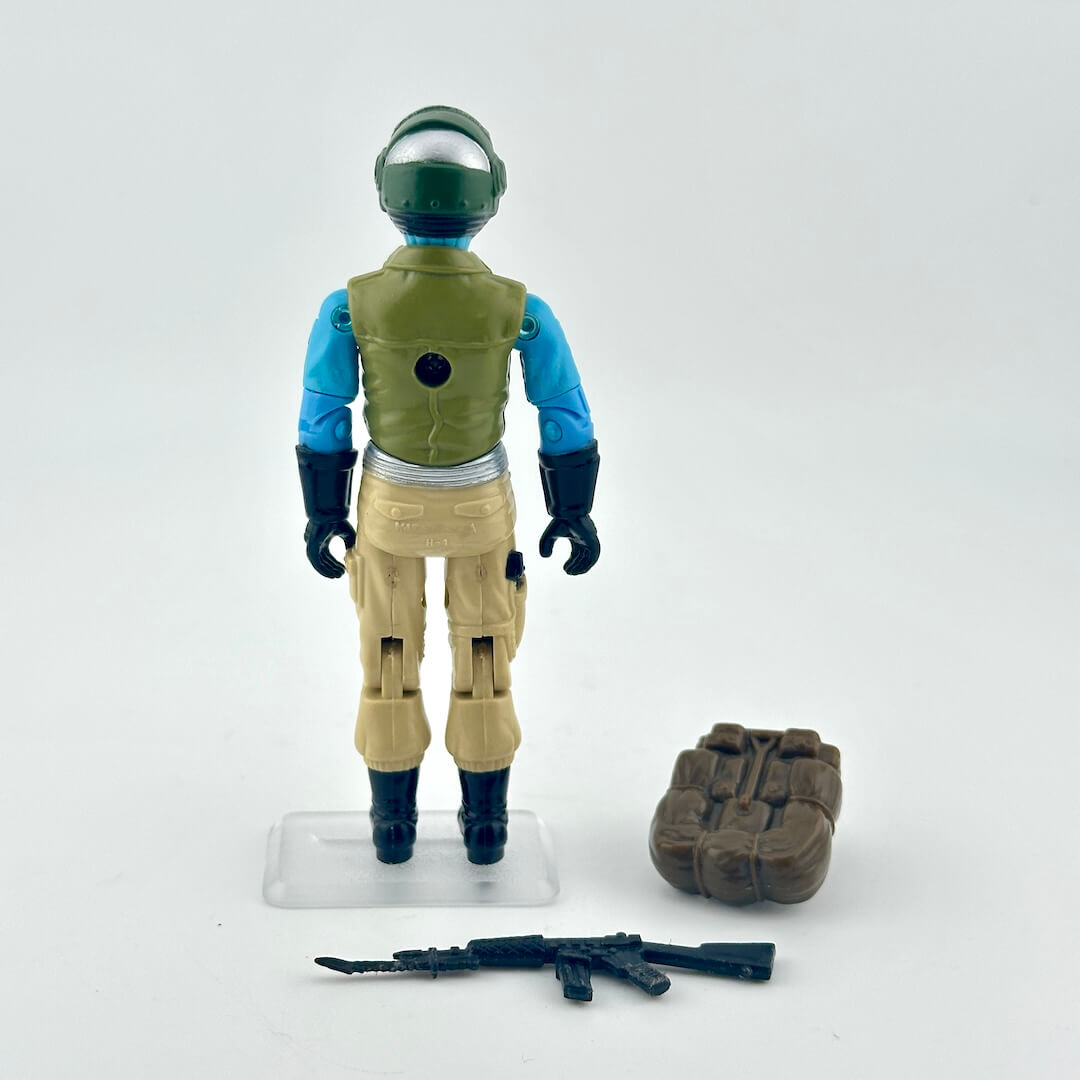 Toy figure in space suit with helmet and weapon on a white background