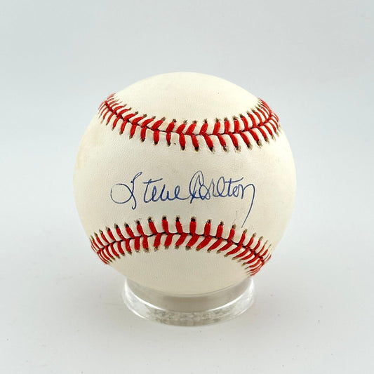 Baseball with red stitching on a white background