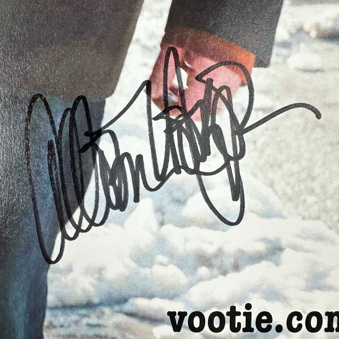 Close up of black marker signature below Earle photo's hand, above "Vootie.com."