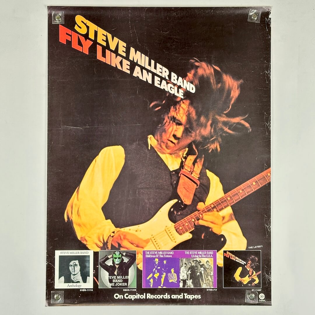 Album cover of 'Fly Like an Eagle' by Steve Miller Band with a person playing guitar.