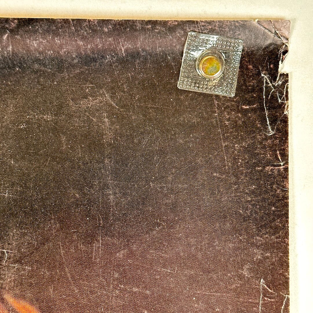 Top right corner of poster with creases and small tear, scratches visible. 