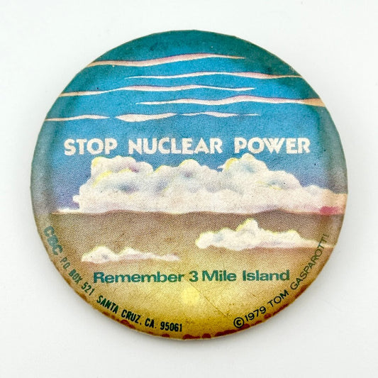 Circular pin with clouds and text, "Stop Nuclear Power, Remember 3 Mile Island."