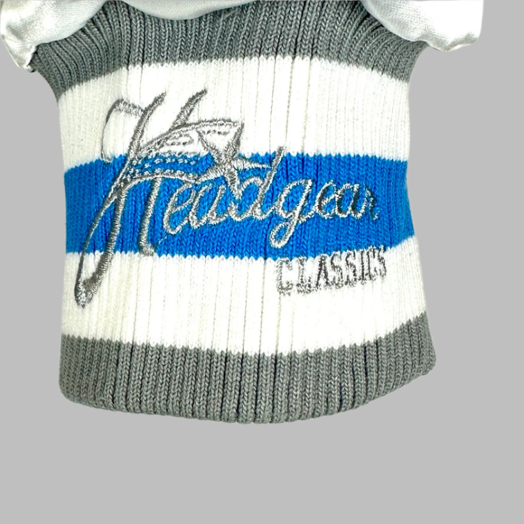 Logo on cuff with grey, white, and blue piping. 