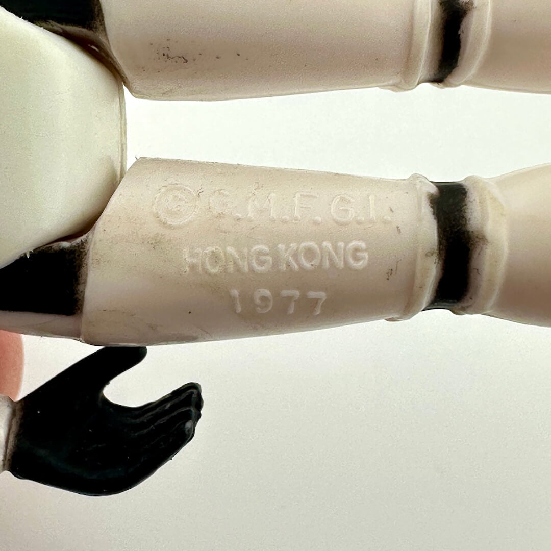 Close-up of back of figure's legs to show COO and manufacturer information. 