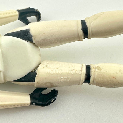 Back of figure's legs to show COO and copyright information. 