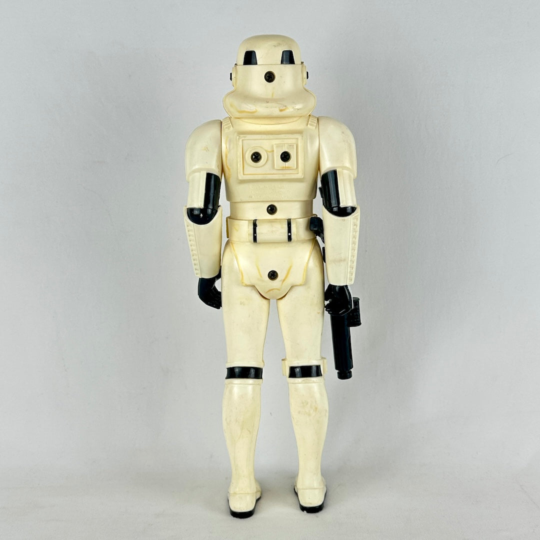 Vintage stormtrooper action figure from Star Wars on a gray background