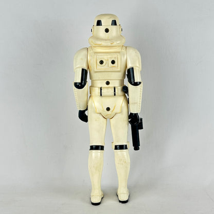Vintage stormtrooper action figure from Star Wars on a gray background