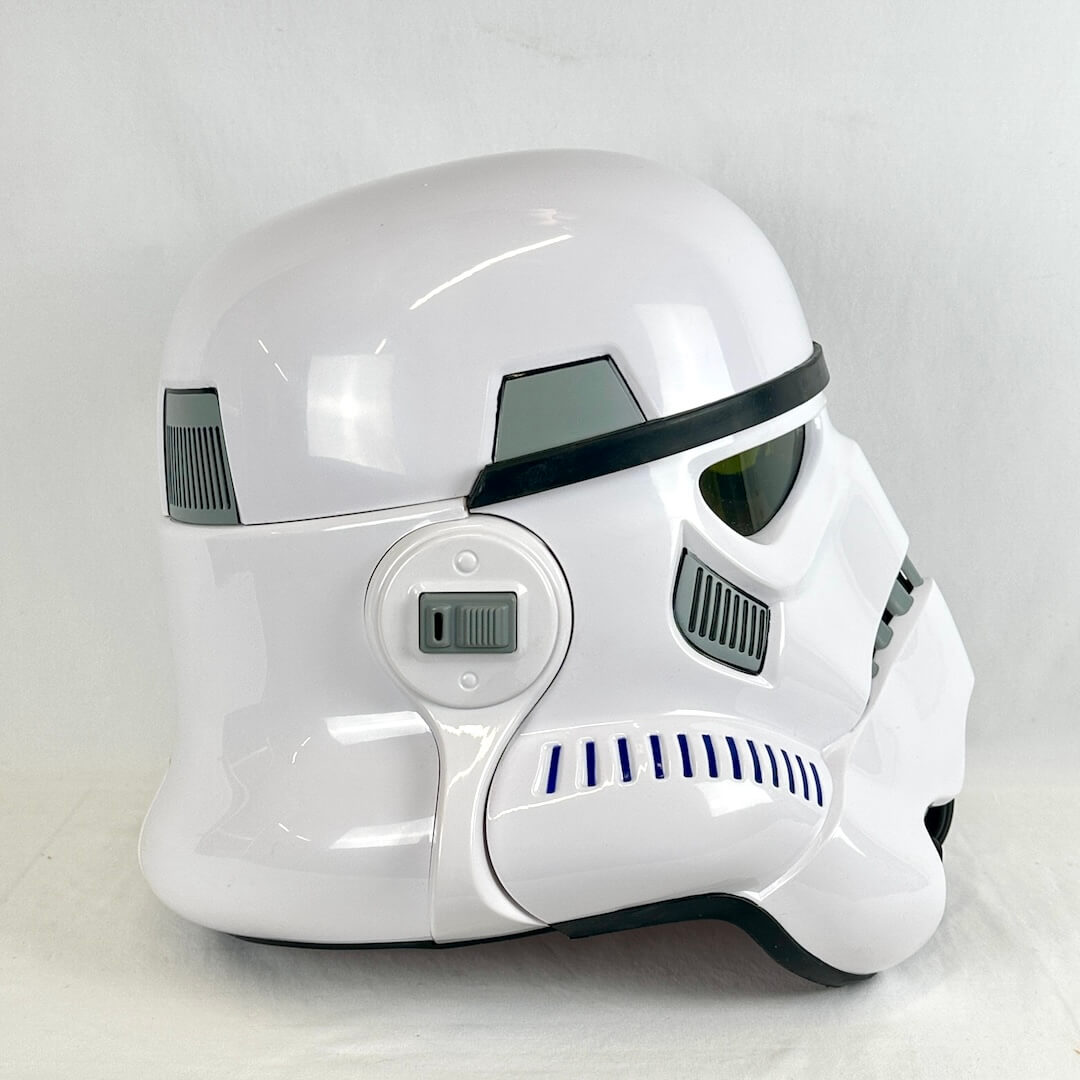 A glossy white stormtrooper-style helmet photographed from the side against a plain light gray background.
