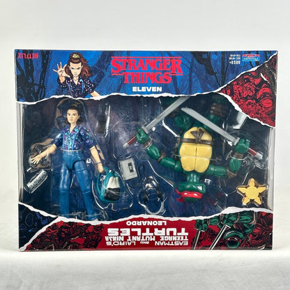 A boxed action figure set featuring a Teenage Mutant Ninja Turtles Eleven figure and a Leonardo figure in retail packaging.