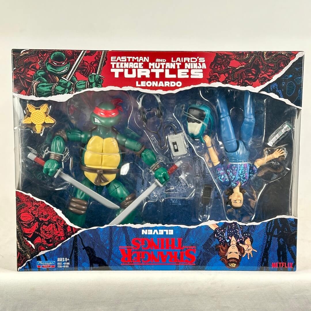 A boxed action figure set featuring a Teenage Mutant Ninja Turtles Eleven figure and a Leonardo figure in retail packaging.