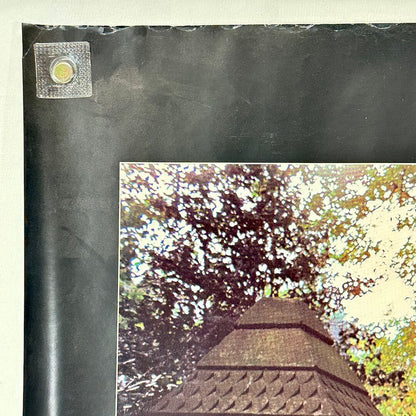 Top left corner of poster with wear to top edge. 