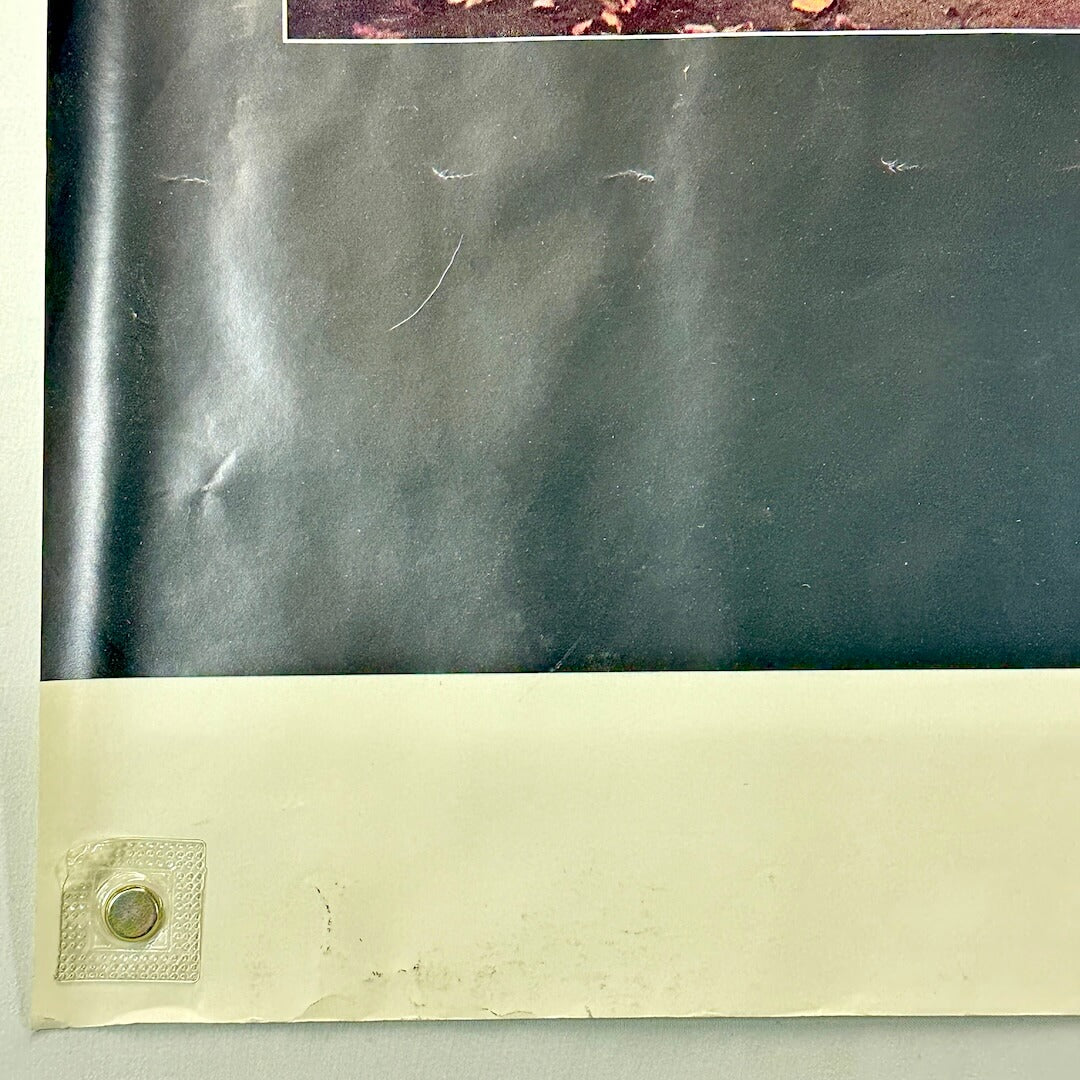 Bottom left corner of poster with some dents to face, and wear to bottom edge. 