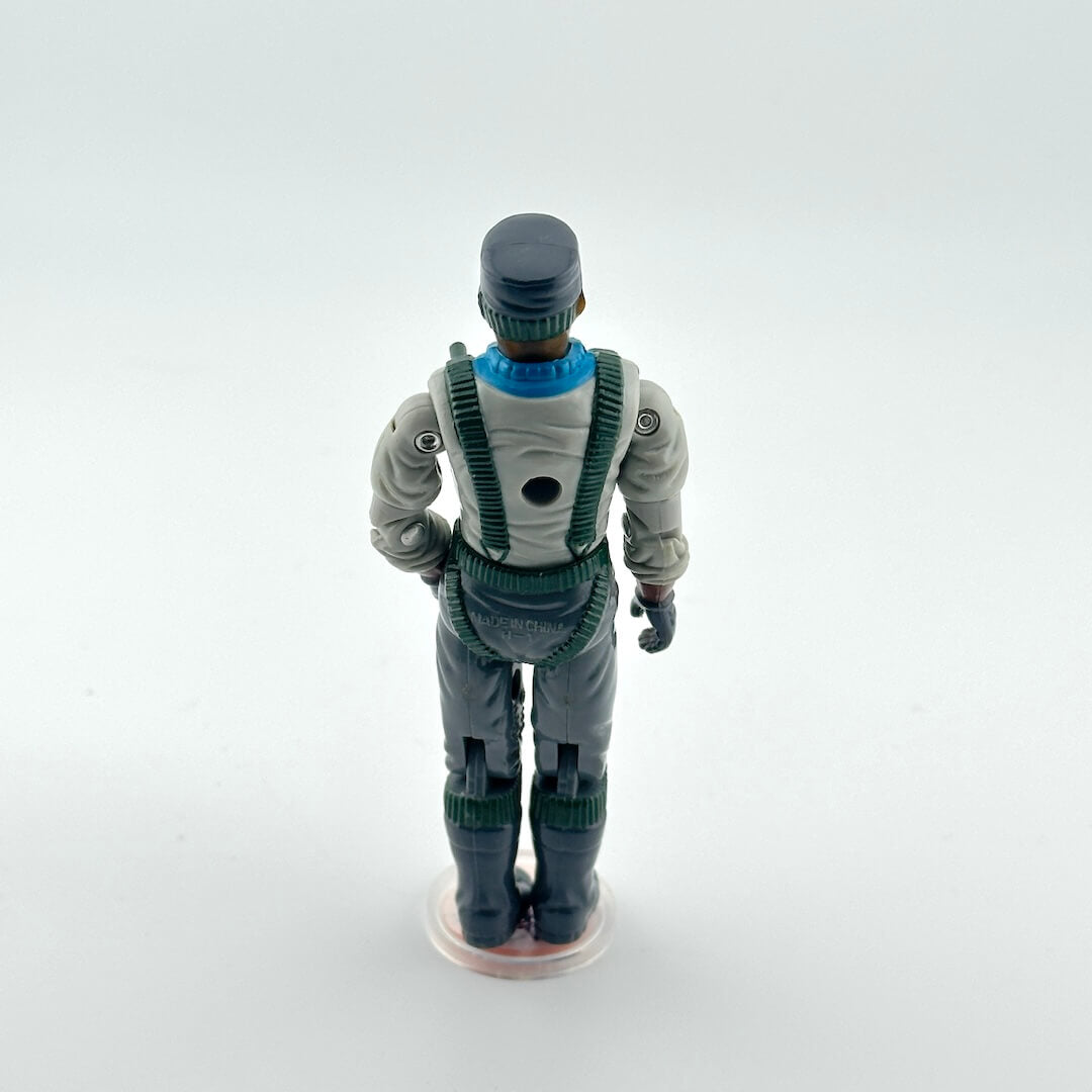 Action figure in a gray and green suit on a white background
