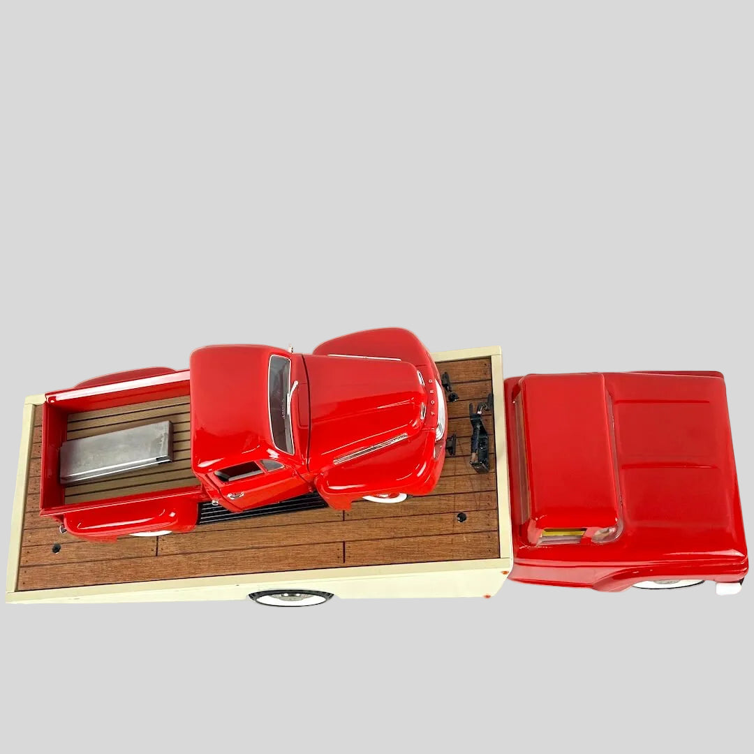 Red model car on a wooden display base with a white background