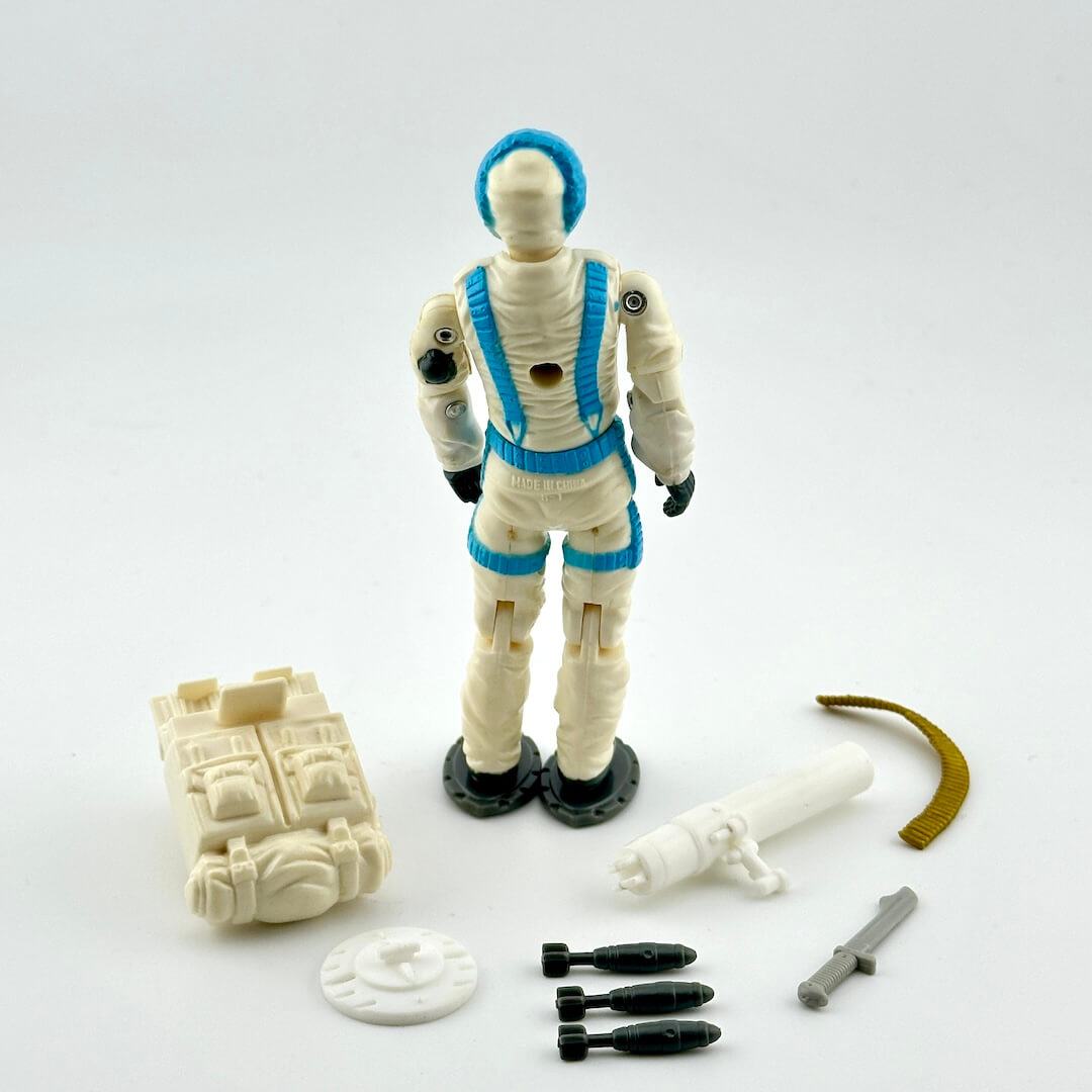 GI Joe action figure with accessories against white background. 
