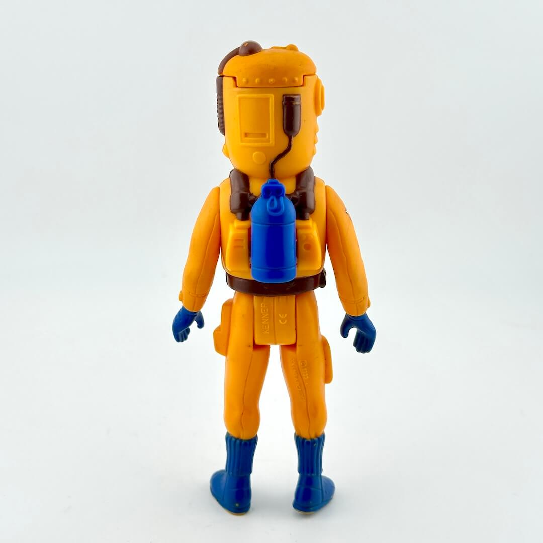 Toy figure in a yellow space suit with blue boots on a white background