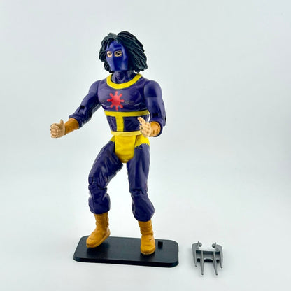 Action figure in a blue and yellow costume with a red emblem on a white background