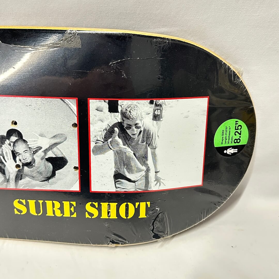 Right side of deck showing images from Sure Shot video, as well as green retail sticker with information about board. 