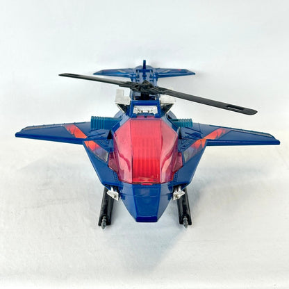 A blue toy jet fighter helicopter with a translucent red canopy and black rotor blades.