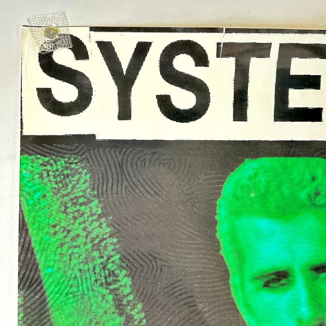 Top left corner of poster with small tear to edge and some wear.