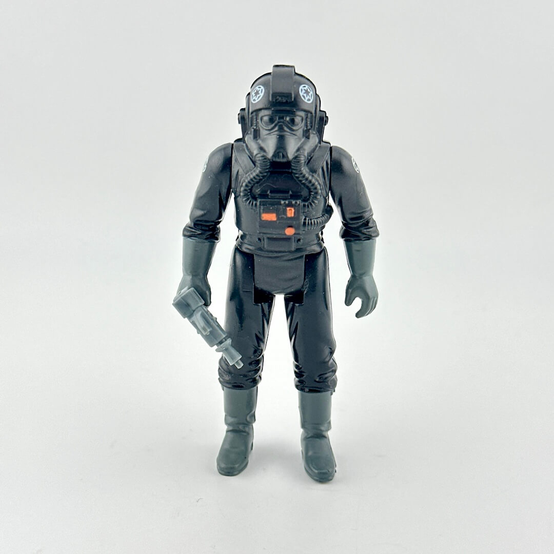 Toy figure in a detailed black suit with helmet on a white background