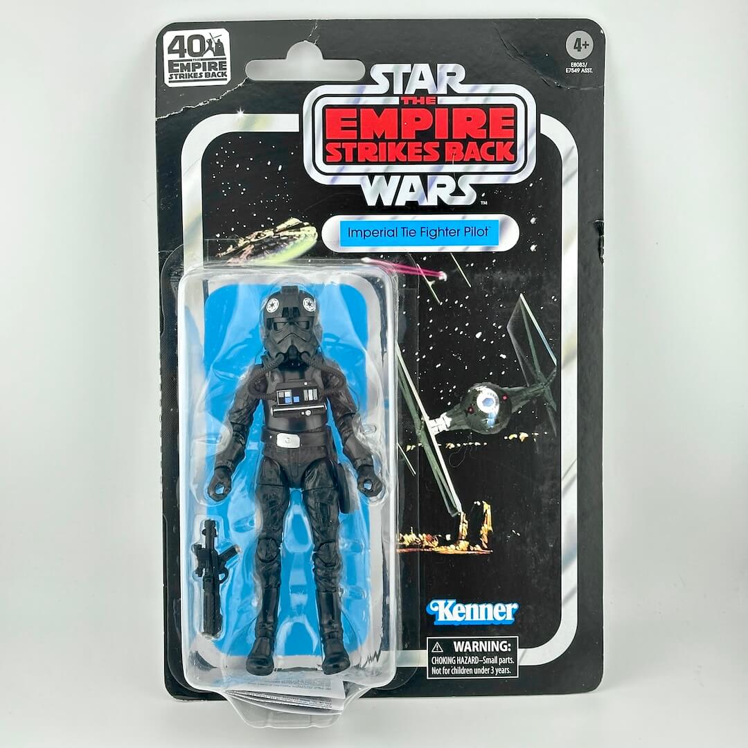Star Wars action figure in original blister packaging with retro-style card back; figure in all black flight suit with accessory.