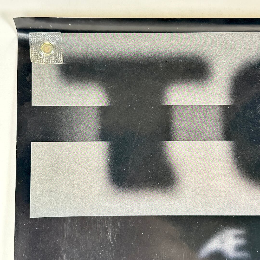 Top left corner with light scratches to face. 