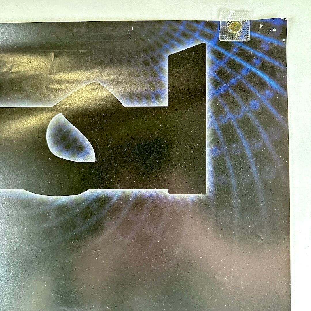 Top right corner of poster with pin holes